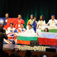 Winning contestants at IOL 2017 being photographed with their medals and country flags