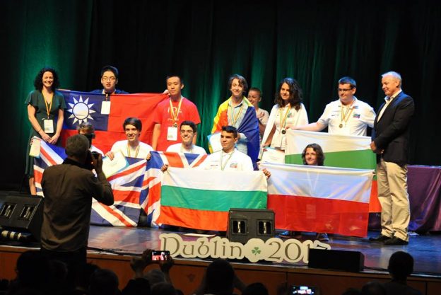 Winning contestants at IOL 2017 being photographed with their medals and country flags