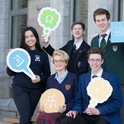 Students holding AILO signs for AILO 2018 National Final