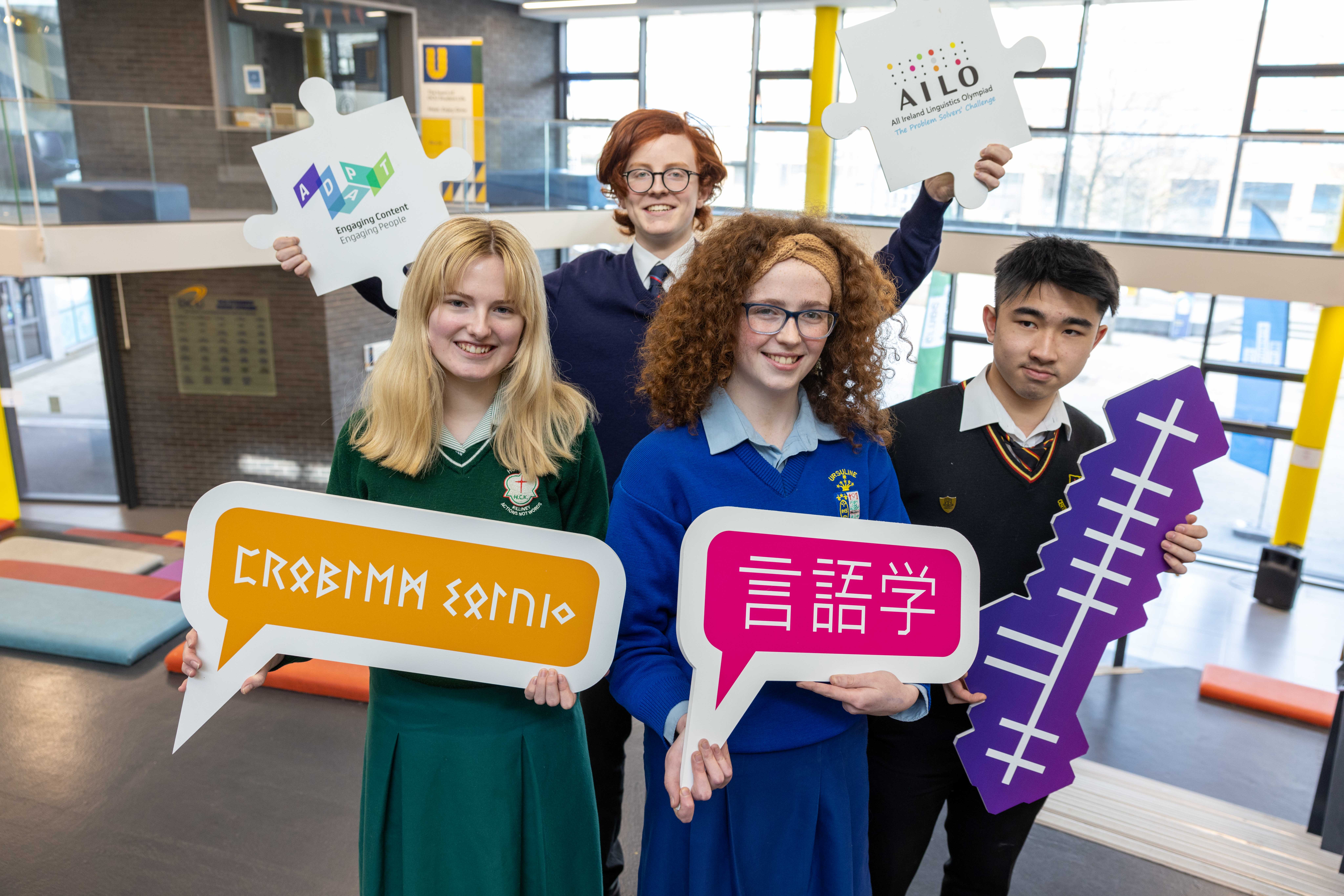 AILO 2023 Participants pose for photo with signs